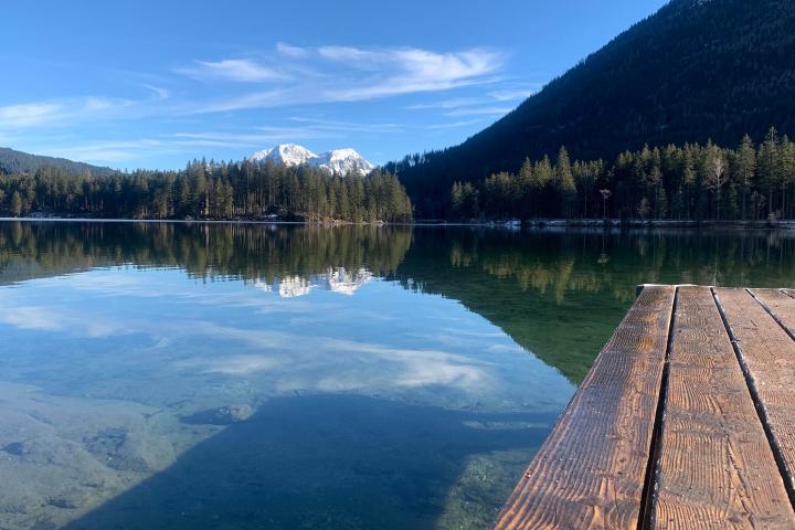 a bridge over a body of water with a mountain in the background